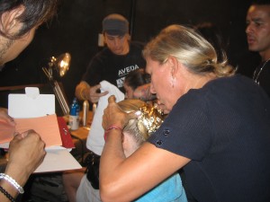 Odile applying gold foil to a model's hair at Rodarte