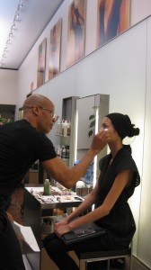 Rudy Miles applies makeup on a model.