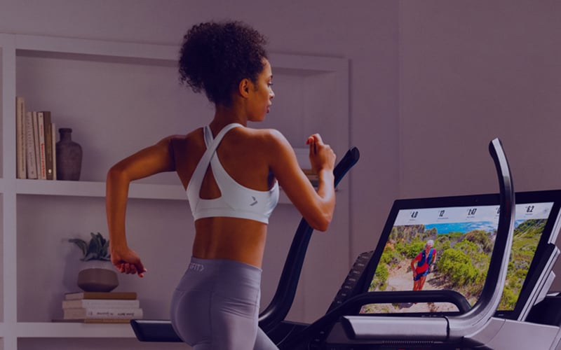 Woman using iFIT on treadmill