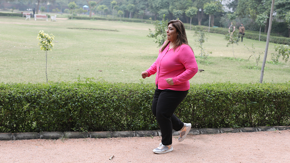 Overweight woman jogging in a park