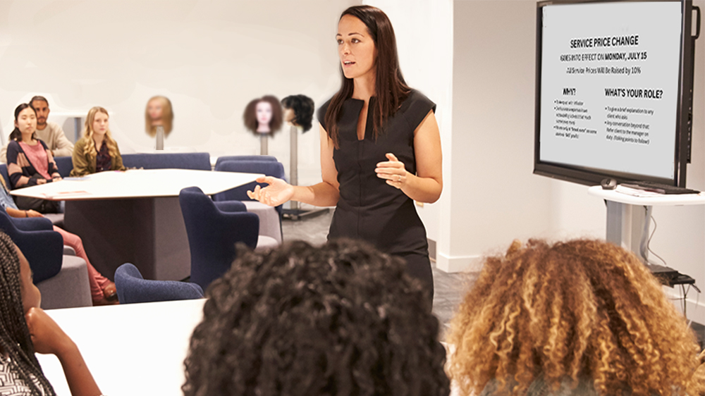 Female salon owner holds team meeting with salon employees