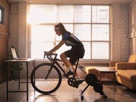 woman on indoor cycle working out online