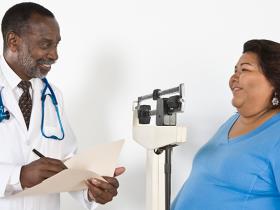 Doctor with patient who is obese