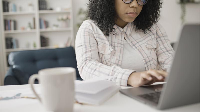 salon owner writing marketing copy on laptop