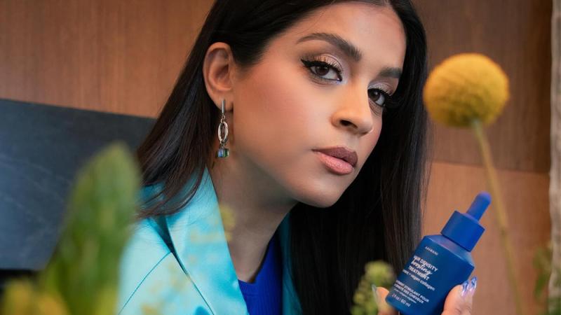 Lilly Singh poses with an AAVRANI product in her collaboration with the brand's new hair-care line