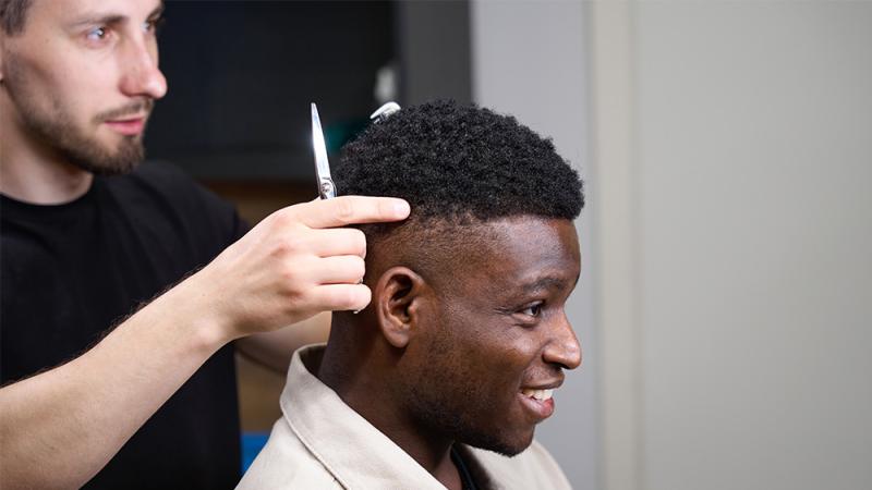 Male stylist and male client with Afro textured hair
