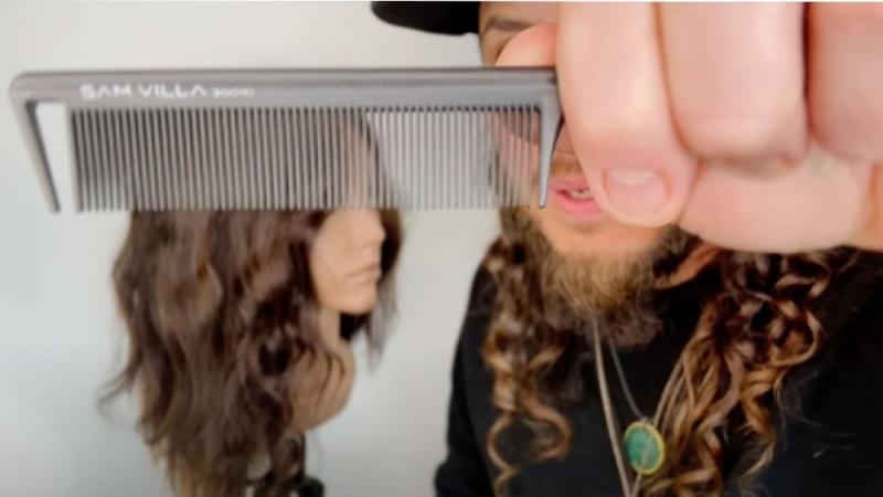 Stylist Roger Molina demonstrates the technique of creating raw waves with a flat iron and comb.