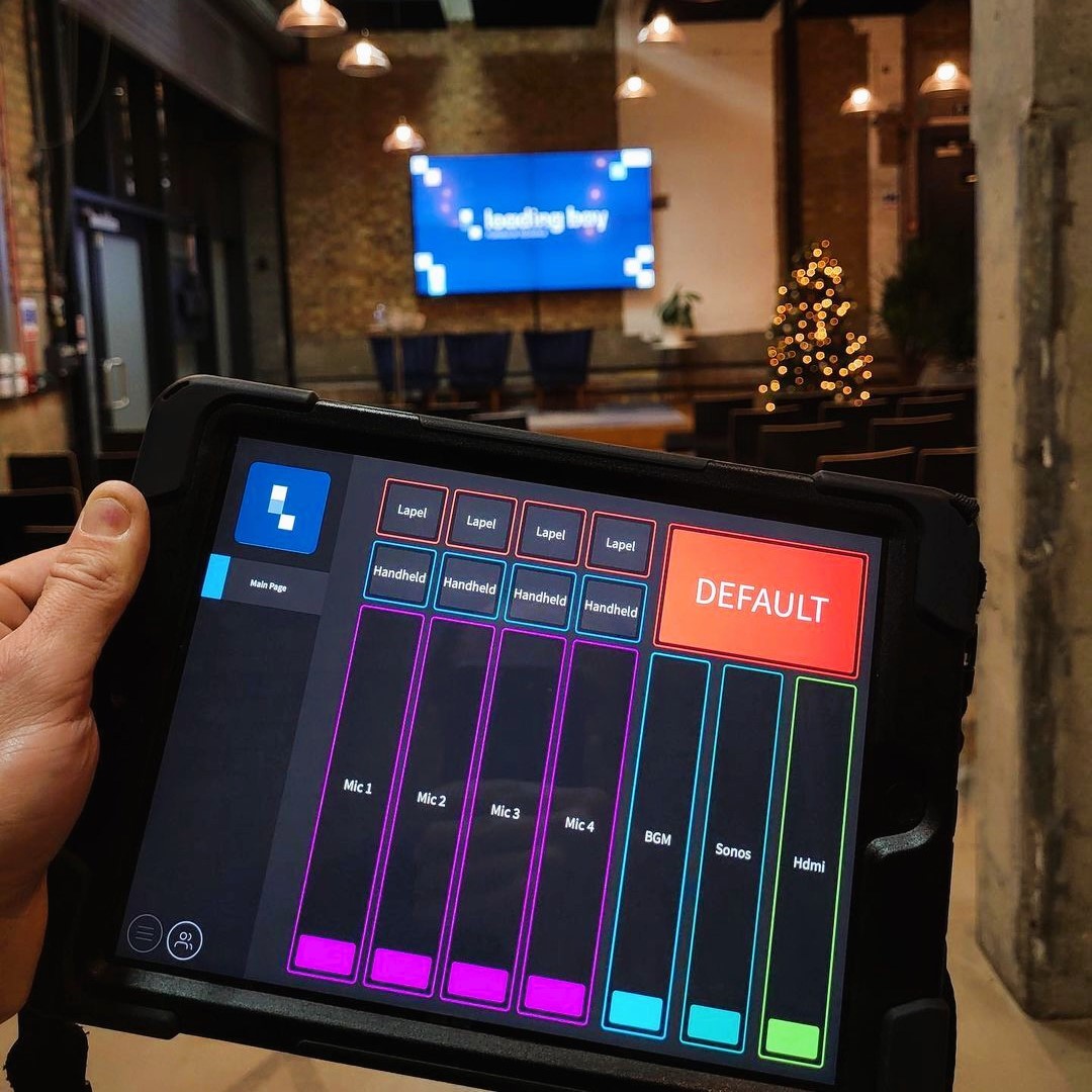 Ctrl for iPad controlling audio levels - the interface shows seven sliders and 9 buttons alongside a venue logo in a corporat