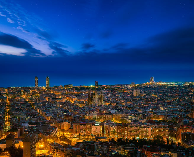 Barcelona city skyline in night time with star and sea background