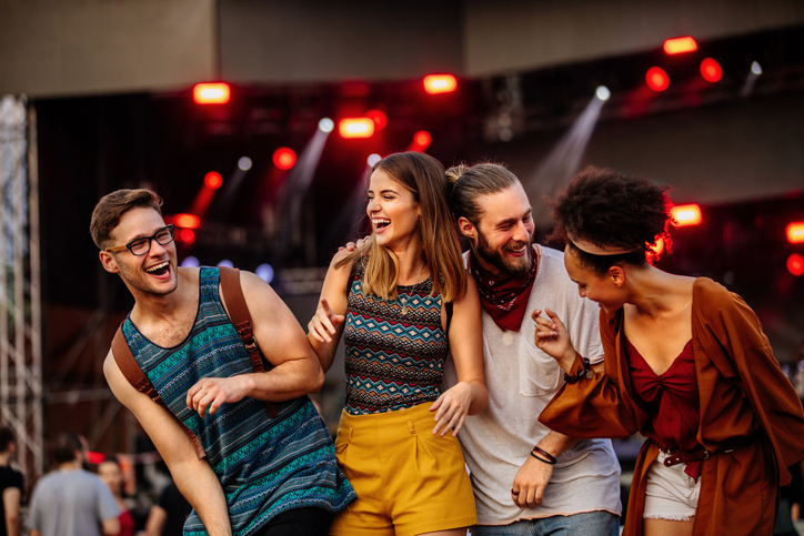 Friends laughing at a music festival
