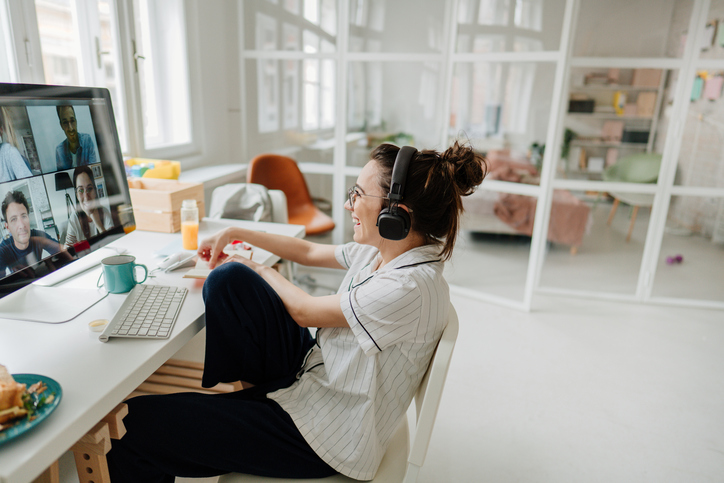 Smiling woman having a video call with her friends 