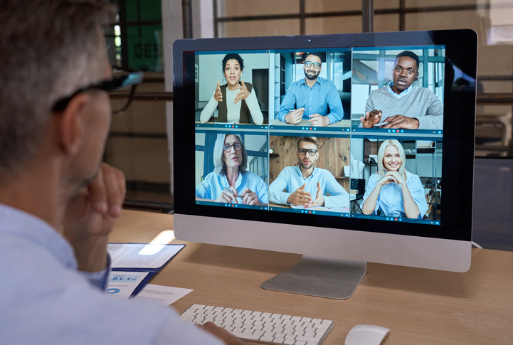 Businessman talking with team leading virtual meeting on computer