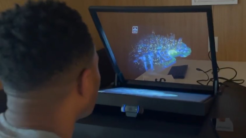man looking at 3d image on screen