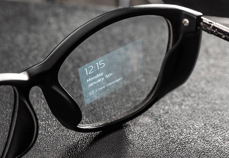 close of lens of eyeglasses showing a message in text over microLED