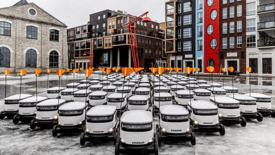 dozens of delivery robots from Starship Technologies in a town square