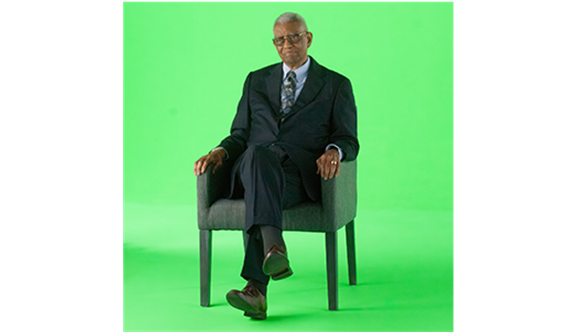 Rev Otis Moss Jr sitting in front of a green screen for AI video experience