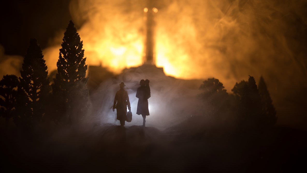 family walking from flames in illo of Ukraine attack by Russia