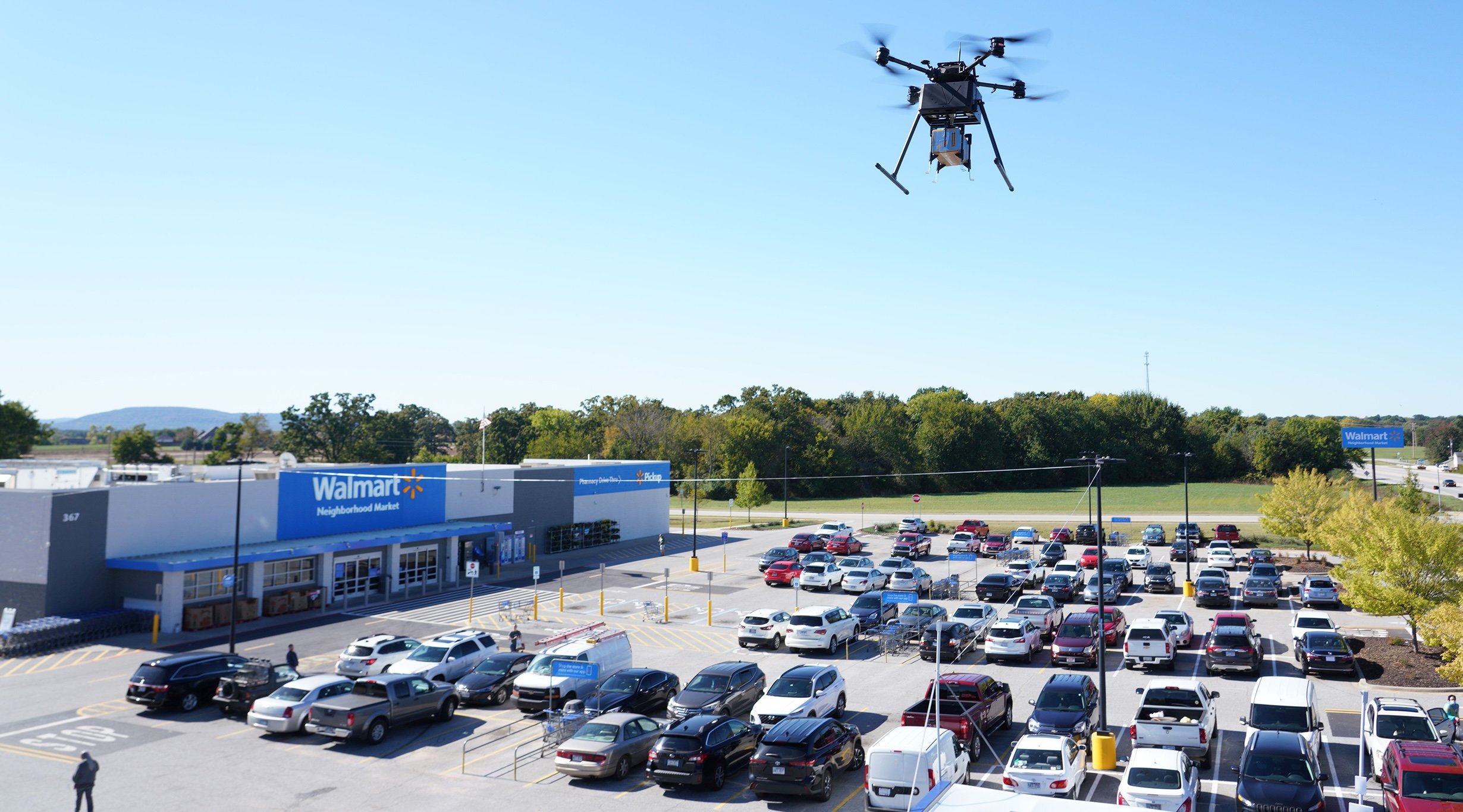 Photo of a modern Walmart superstore from above with a drone flying above the store