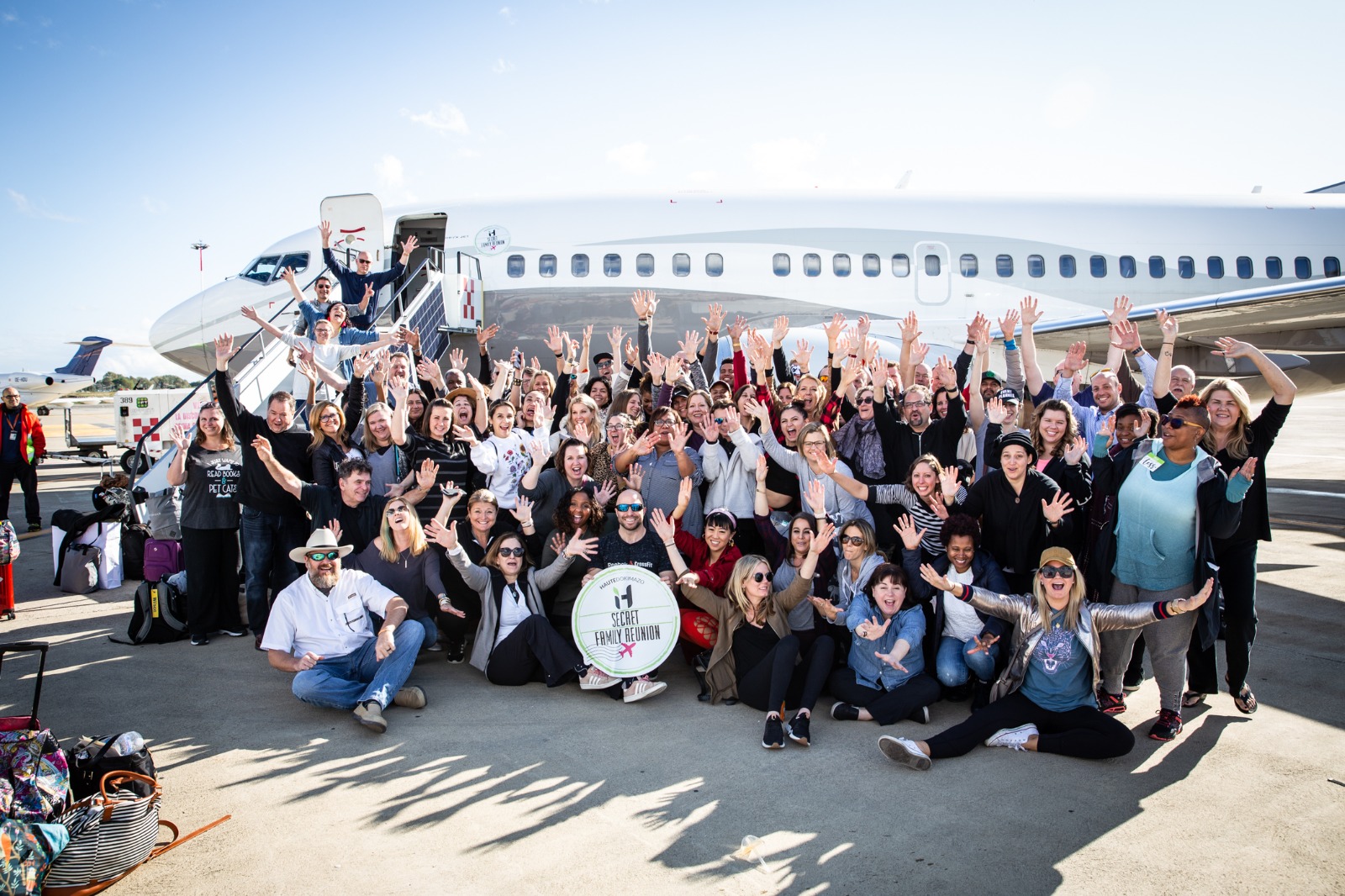 Group photo in front of private jet