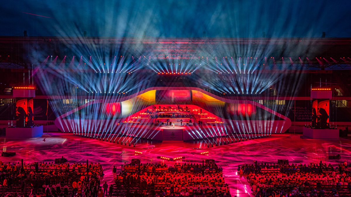 The stage for the Opening ceremonies of the Rhine-Ruhr Games in Germany with lights in blue and pink and athletes on the stag