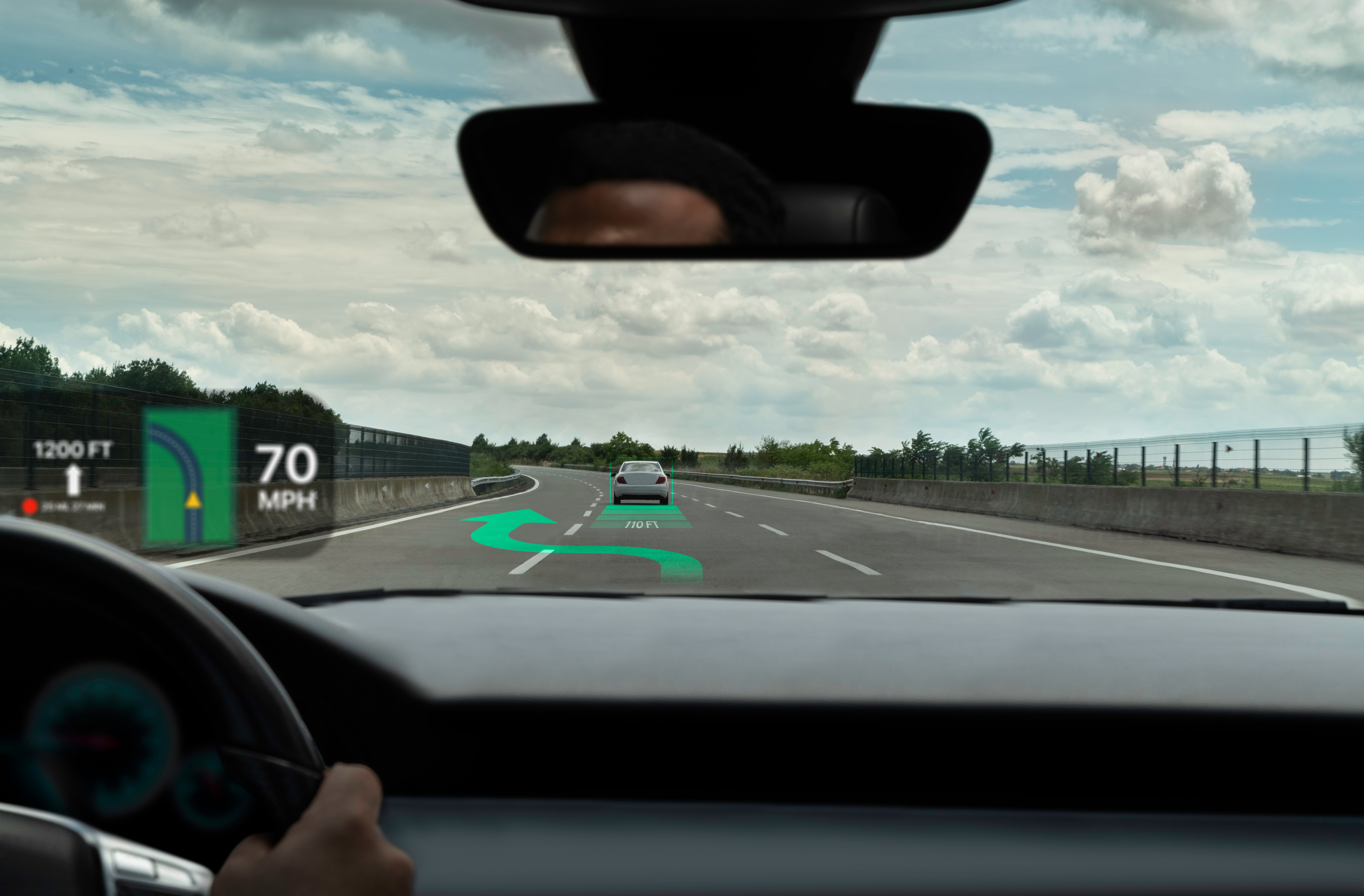 Heads-up display car on road with arrow superimposed on highway