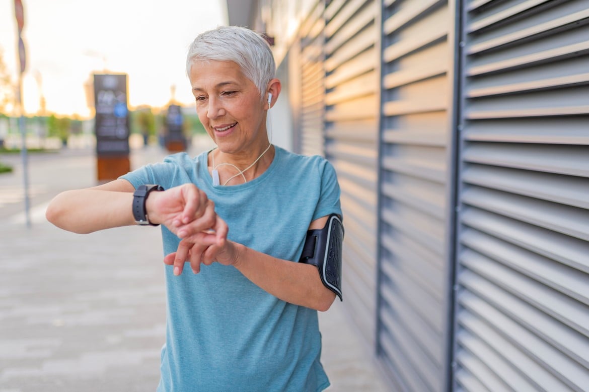 middle aged woman wearing smartwatch for a run