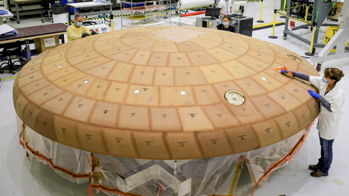 people prep heat shield for Artemis I Orion