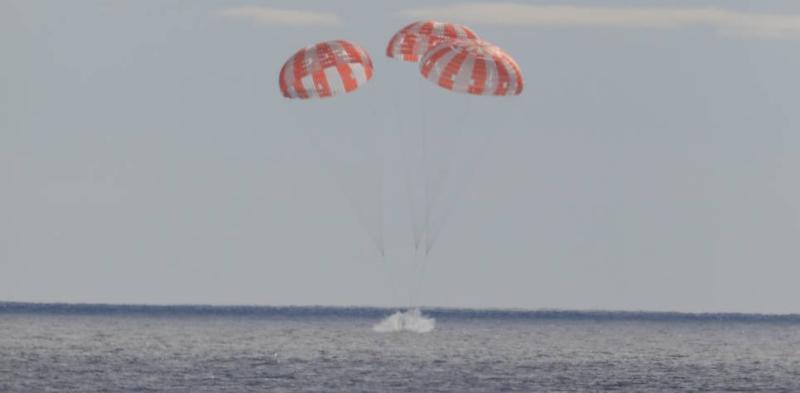 photos shows water and parachutes with Orion 