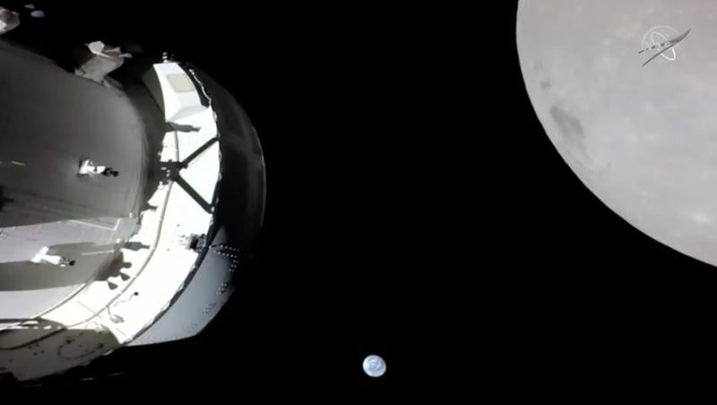 view of Orion spacecraft, moon and Earth taken from solar array camera