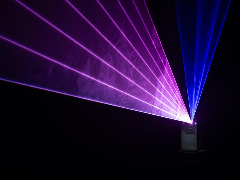 X-Laser Triton T Series projecting blue and purple beams