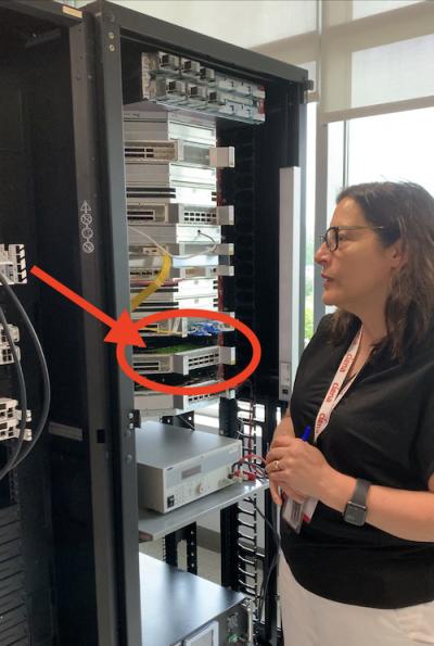 Ciena's Helen Xenos showing a liquid cooling demo. Source: Silverlinings