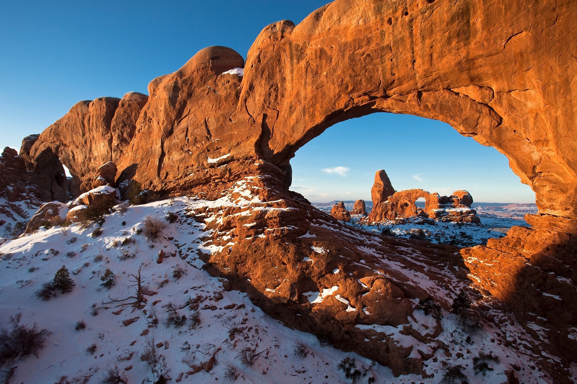Utah arched rock formation and snow-covered ground
