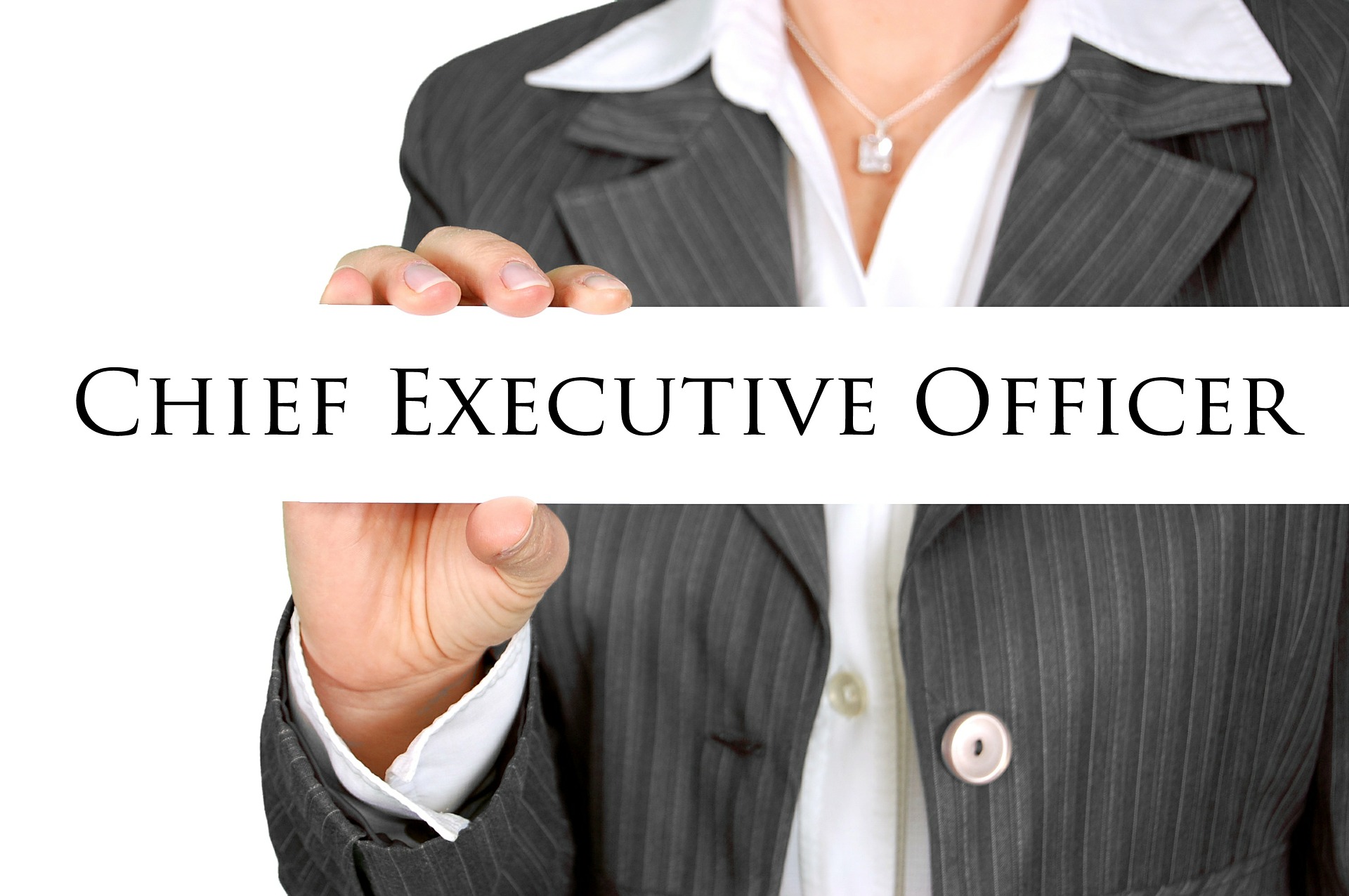 Woman in business suit holding a sign that says chief executive officer