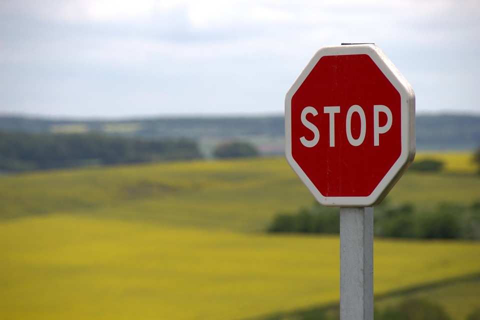 Stop sign with field in background