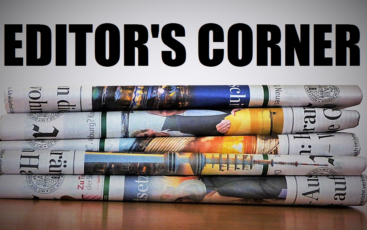 The words Editors Corner in bold letters at the top of a stack of newspapers 
