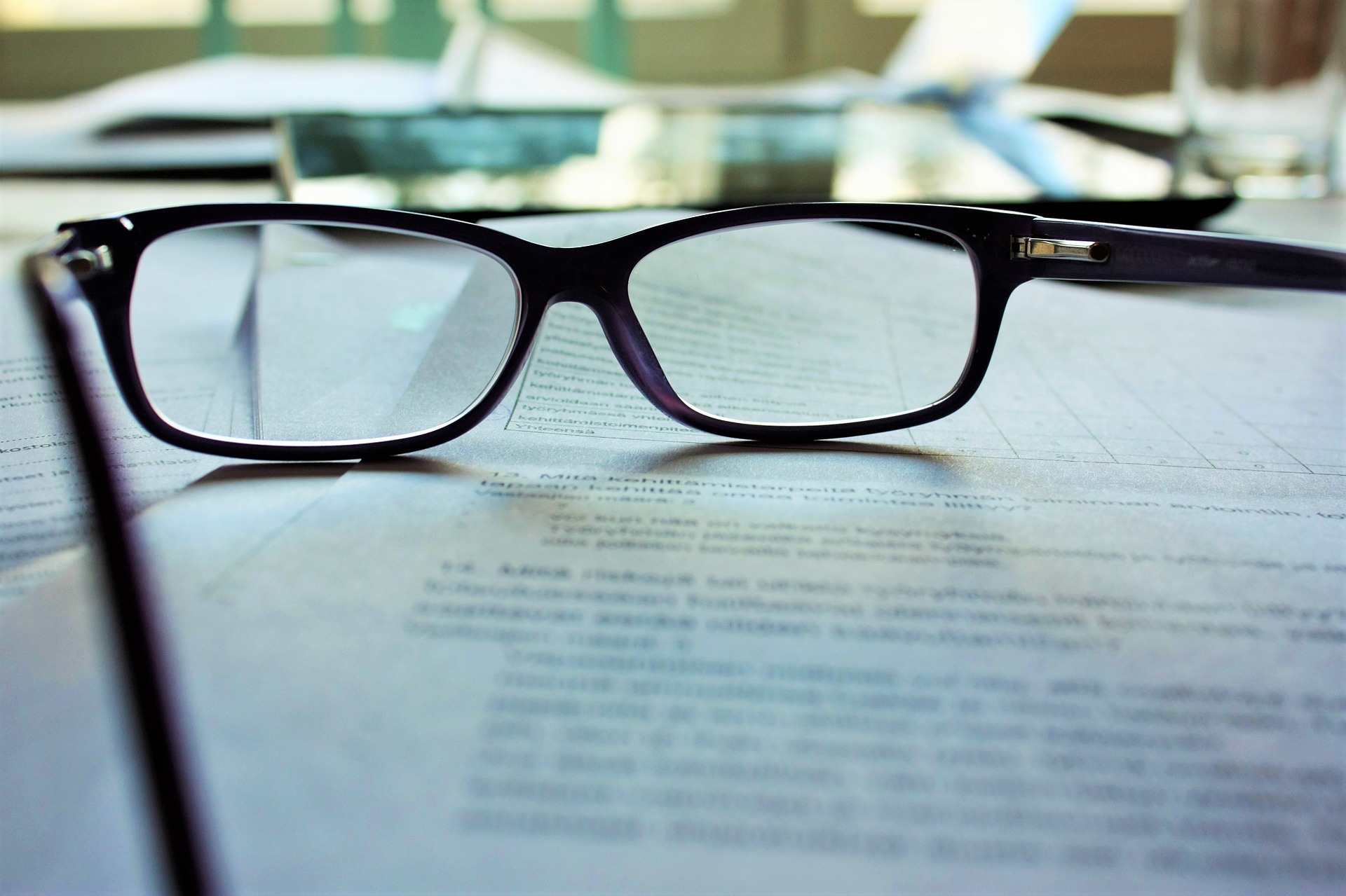 Pair of glasses on top of document