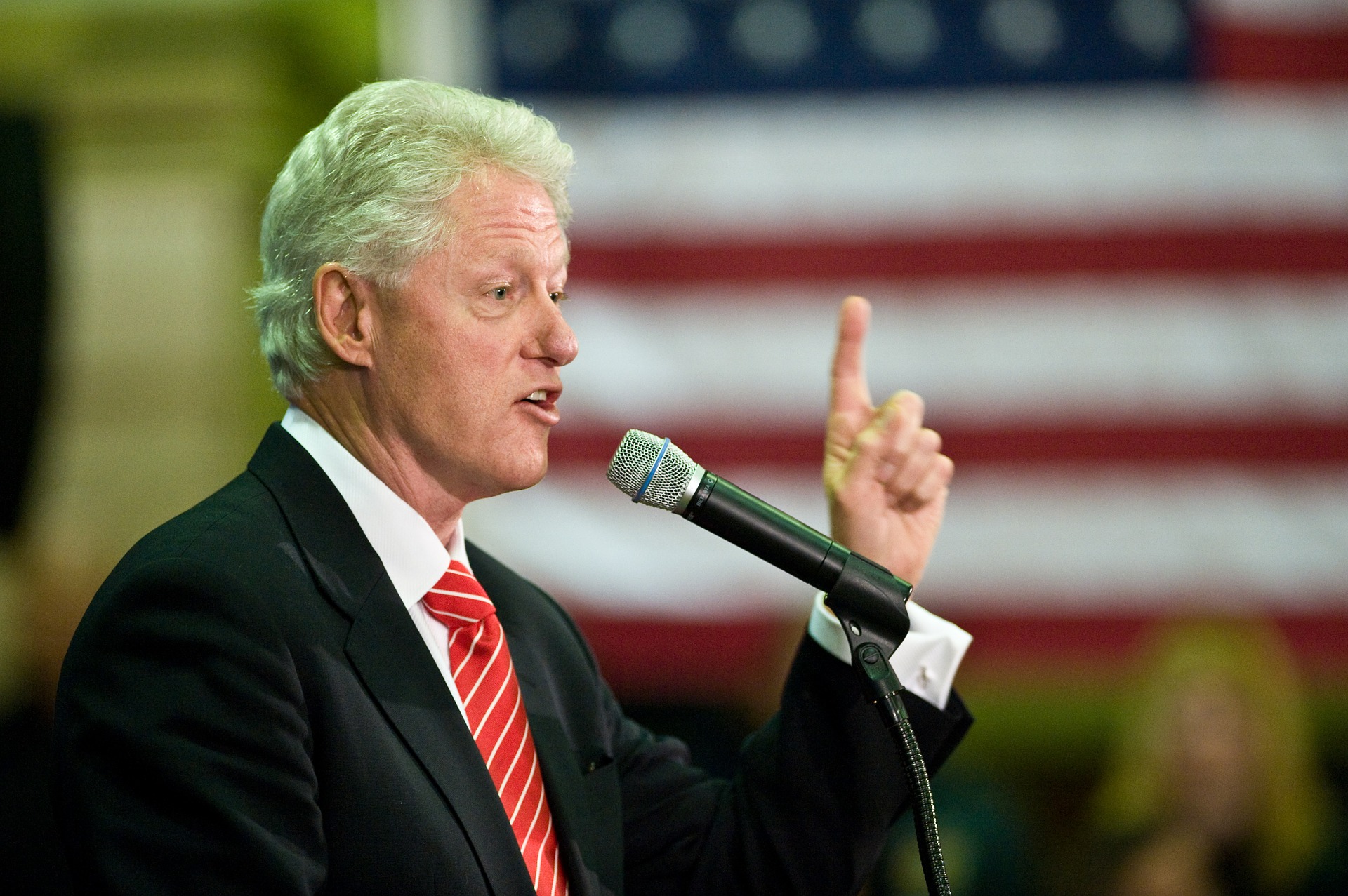 Bill Clinton speaking at lectern 