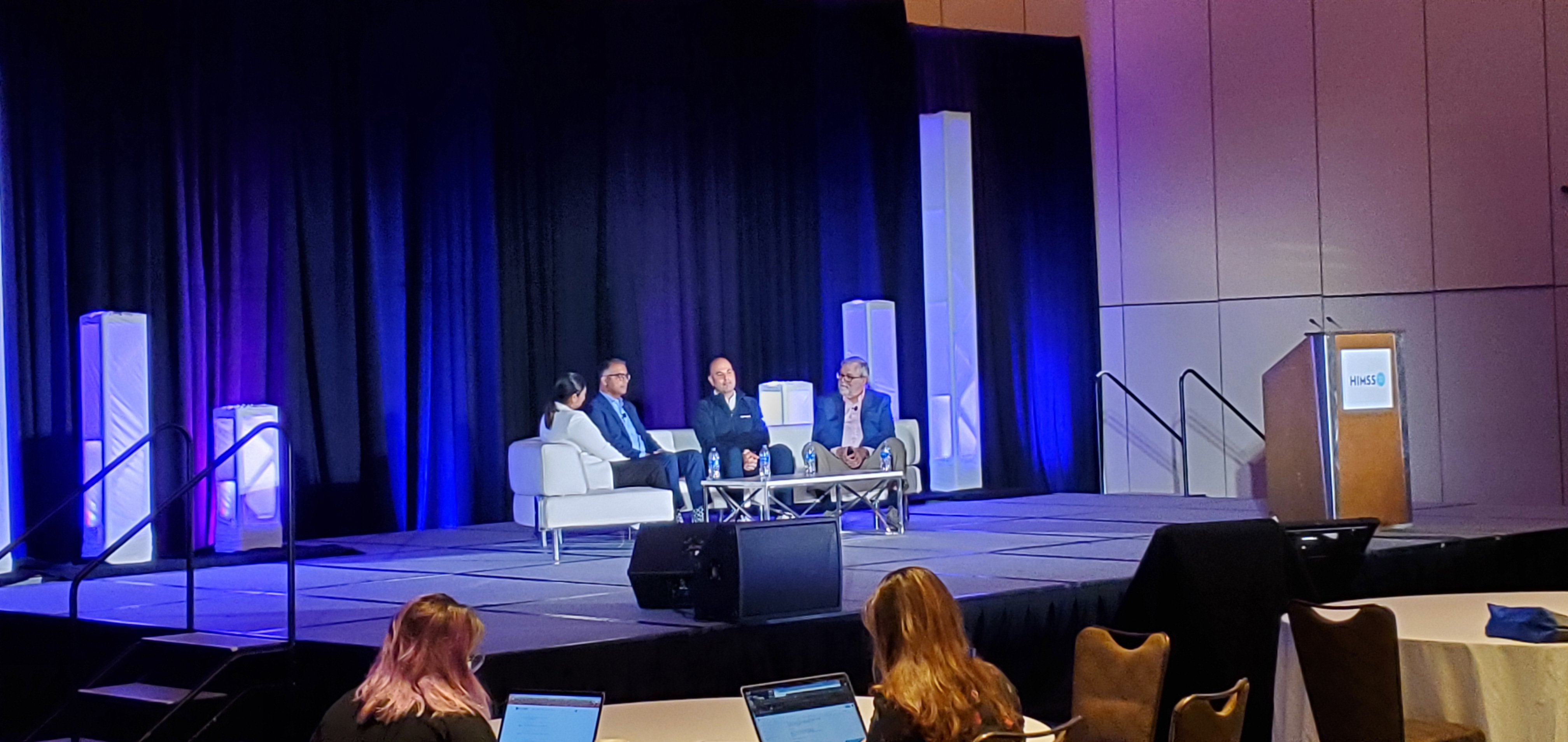 Retail and primary care executives speak on stage at HIMSS 2022