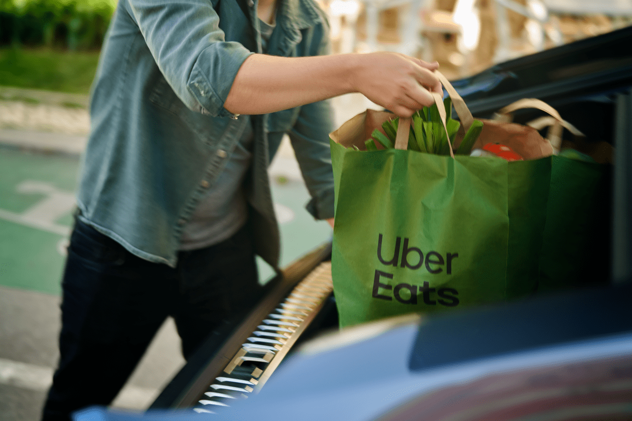 Uber driver picks up Uber Eats delivery out of trunk of car