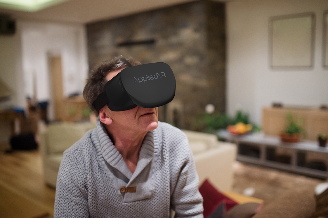 older man using virtual realty headset at home