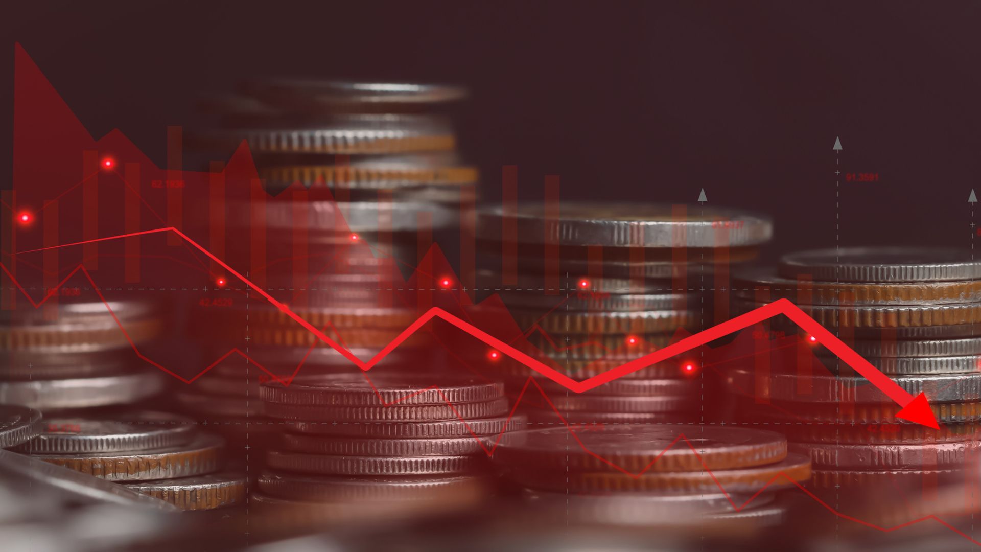 Red graph chart over coins