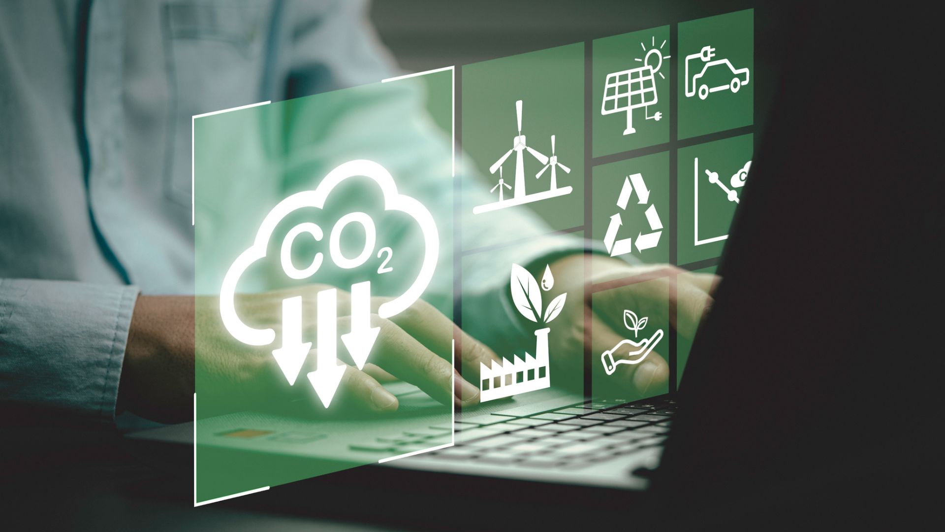 Businessman uses laptop with CO2 reduction icon on screen