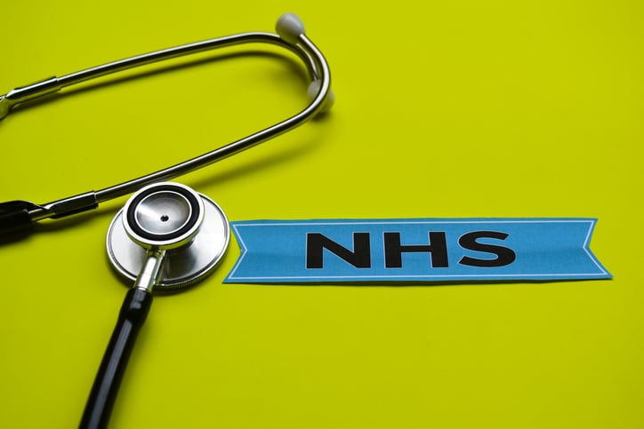 A stethoscope next to a patch reading NHS
