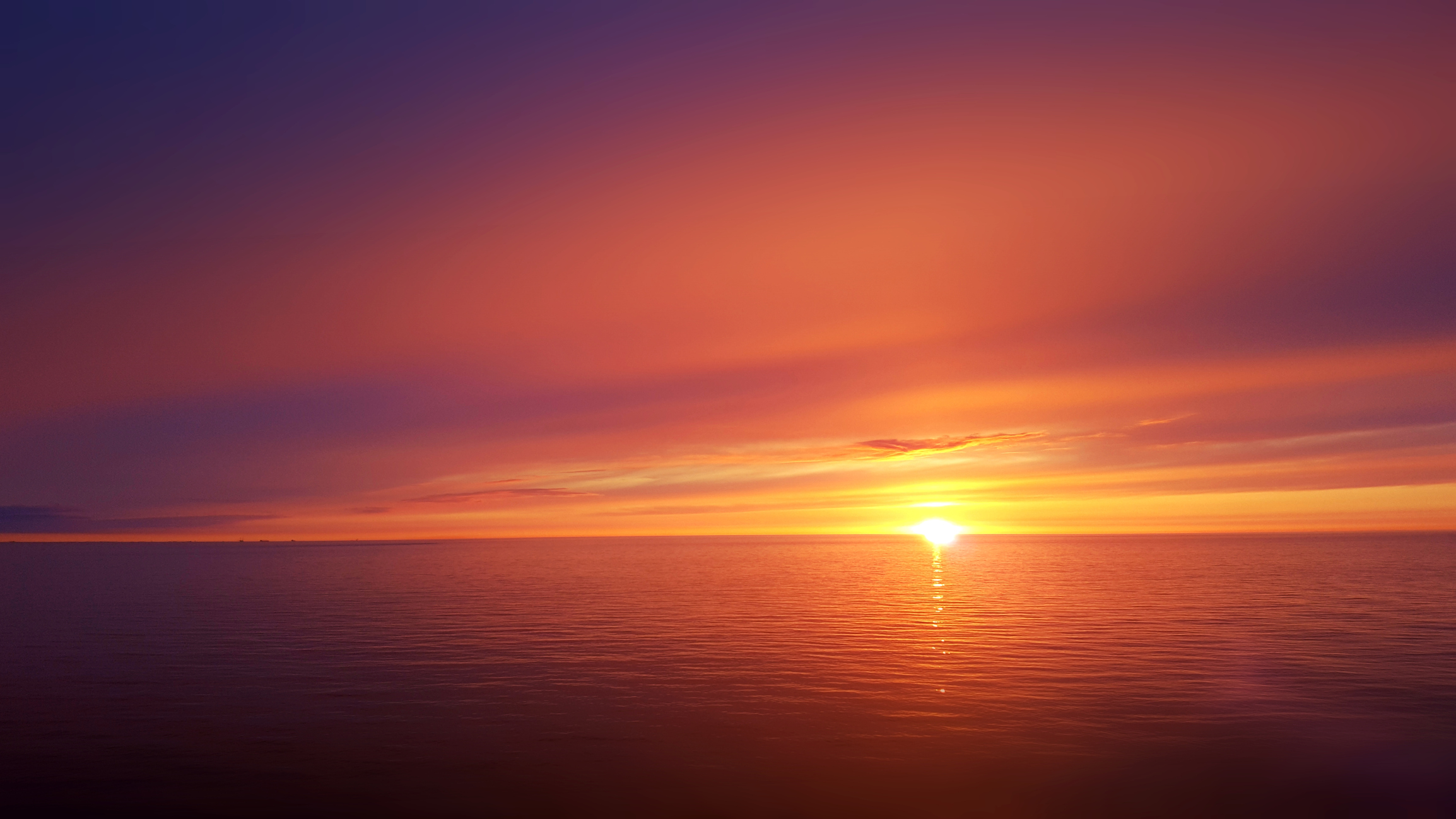Photo of a sunset over the horizon on a body of water