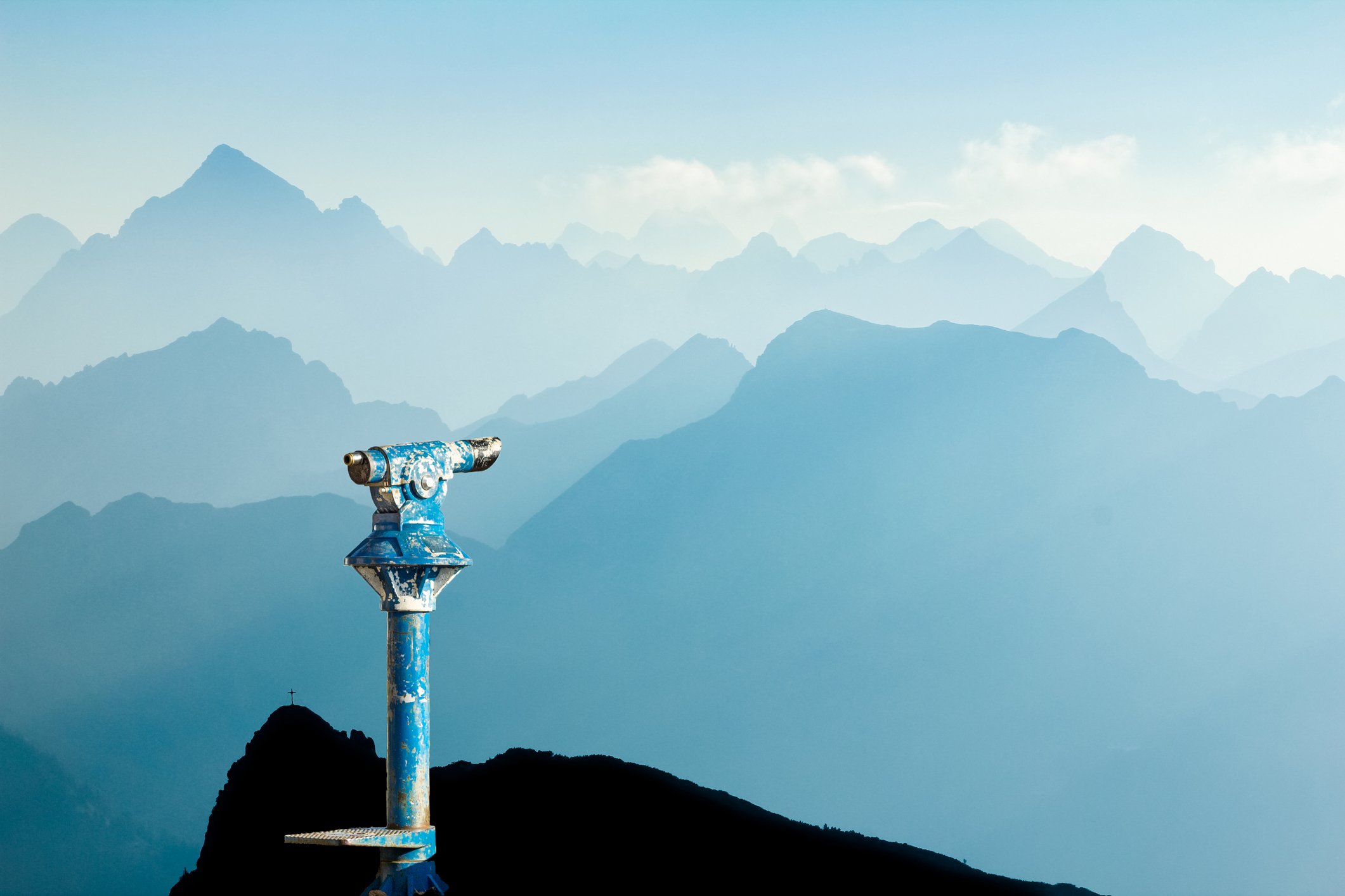 Public binoculars looking out toward mountains vast landscape