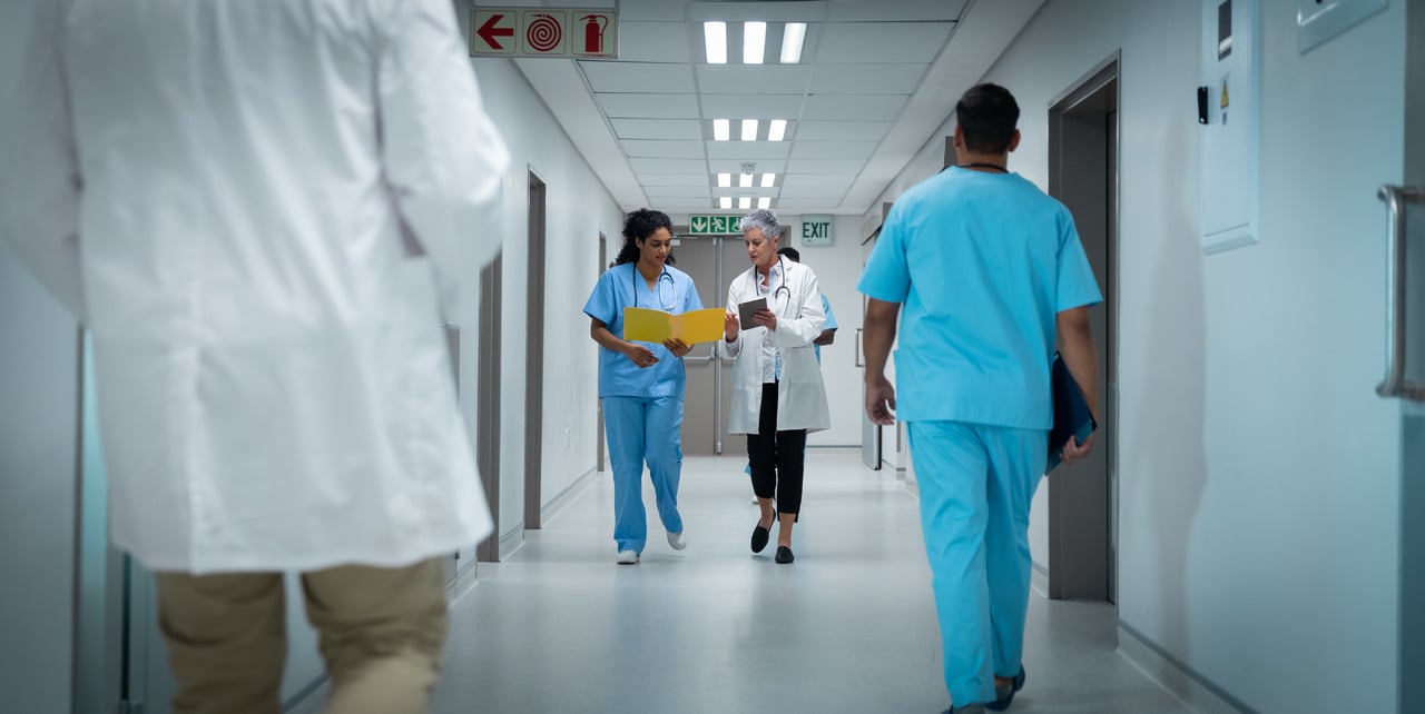 Female doctors walking down hospital corridor