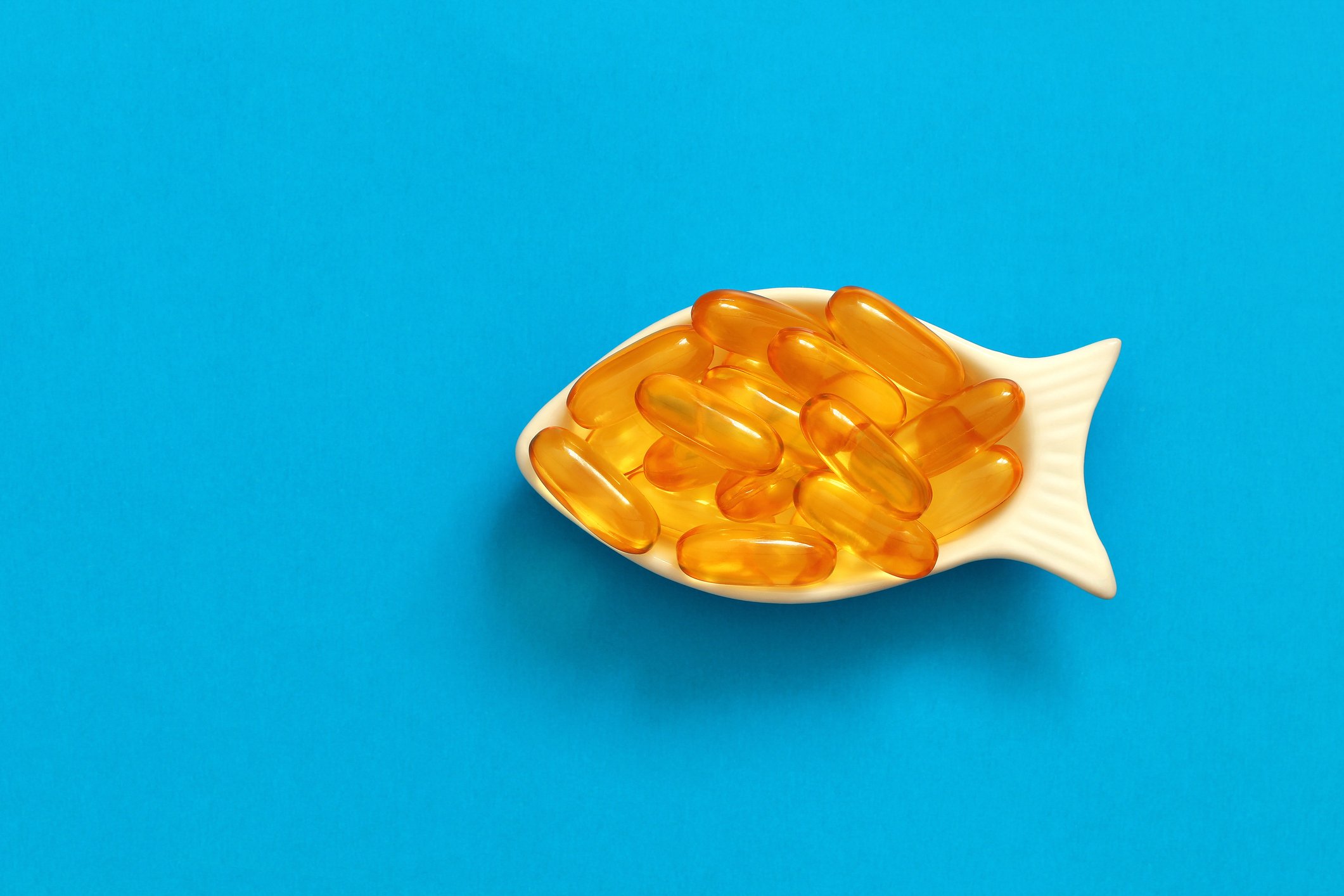 Fish oil pills sitting in a fish-shaped dish