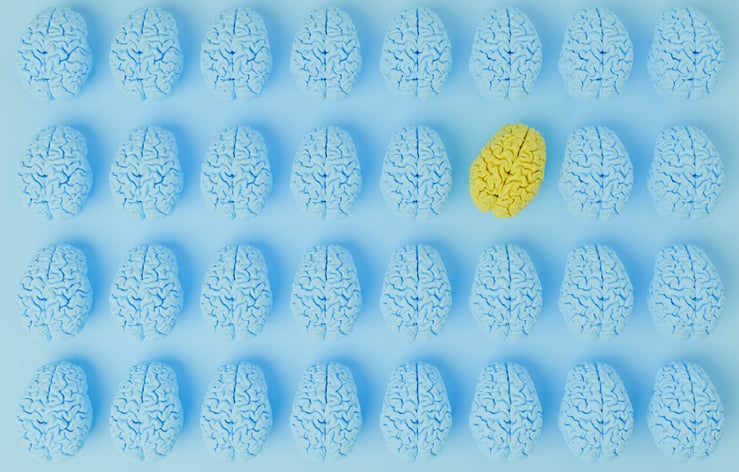 Eight rows of blue brains seen from above on a blue background are punctuated by a bright yellow brain turned at an angle