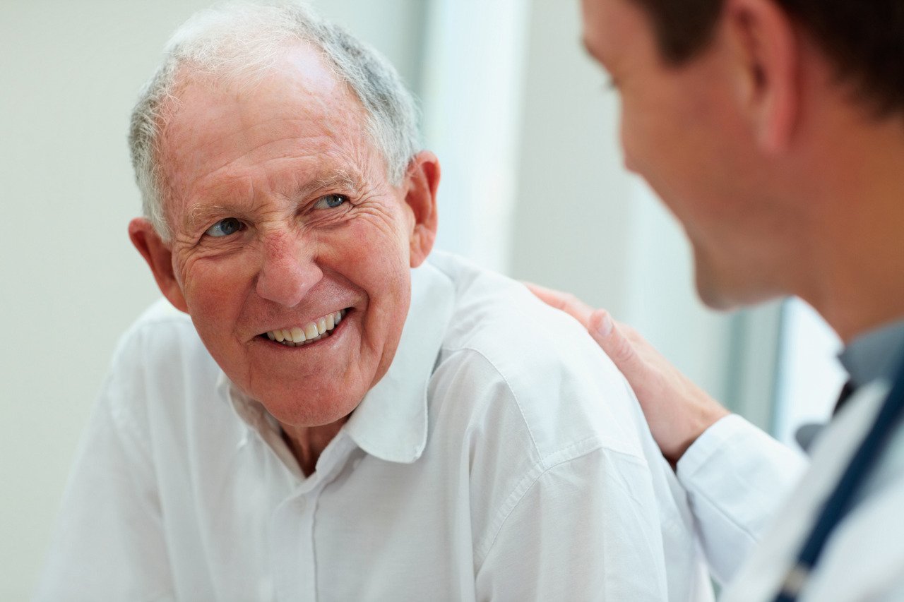 male doctor speaking with older patient