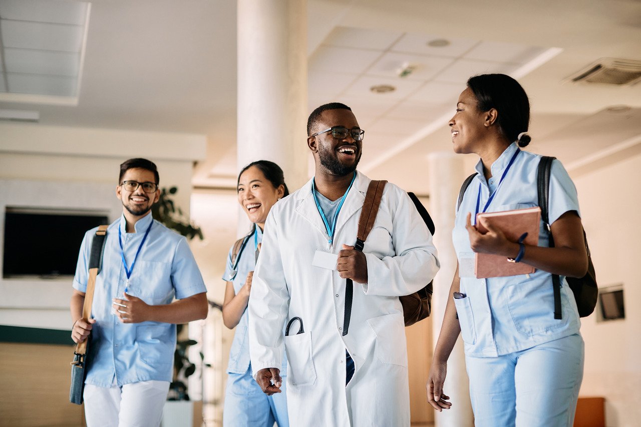 Multiracial group of medical students walking in a hallway at medical university